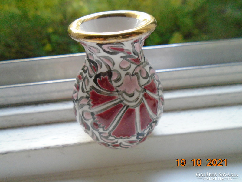 Hand-painted small ceramic vase marked with embossed enamel floral patterns
