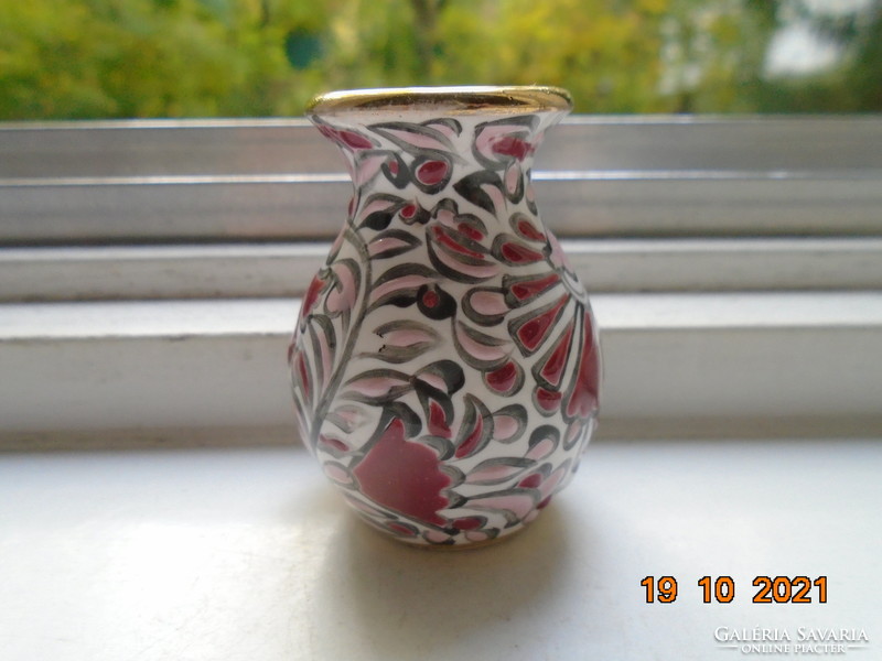 Hand-painted small ceramic vase marked with embossed enamel floral patterns