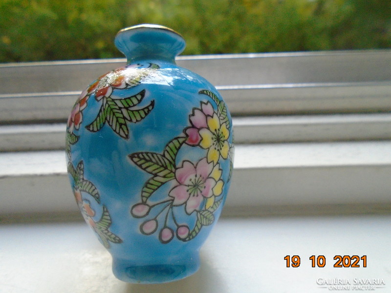 Small turquoise blue Chinese vase with hand painted colorful floral patterns