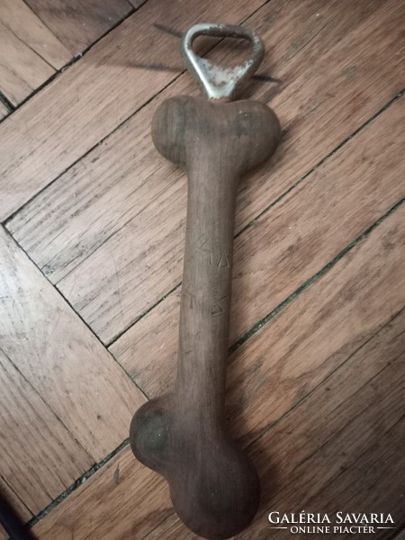 Wooden bone-shaped bottle opener from the 1980s