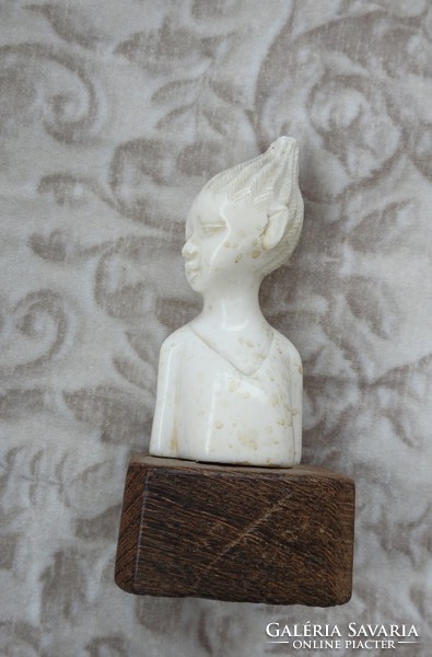 Antique oriental bone sculpture on wooden pedestal