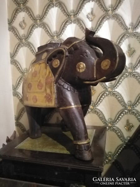 Antique wooden elephant with copper decoration
