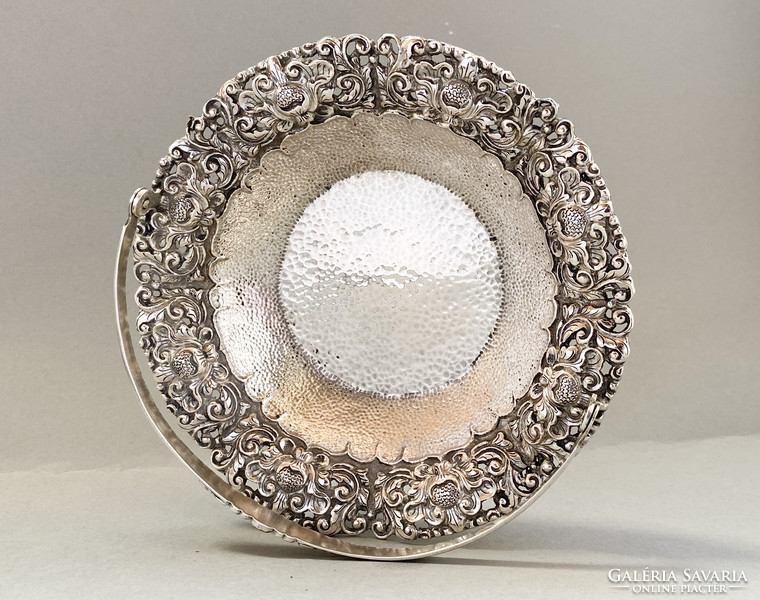 Richly decorated silver serving basket.