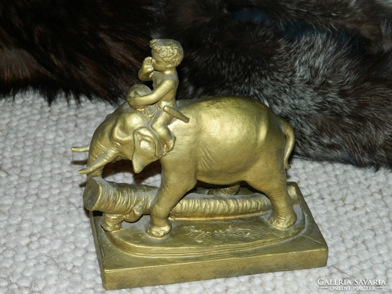 Careful pottery _ child riding an elephant