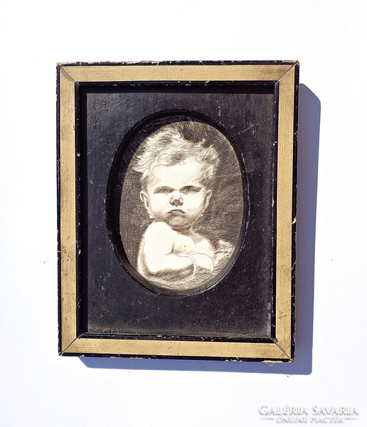 Grumpy little boy scratched on noble bone, in a wooden frame, circa 1920-30