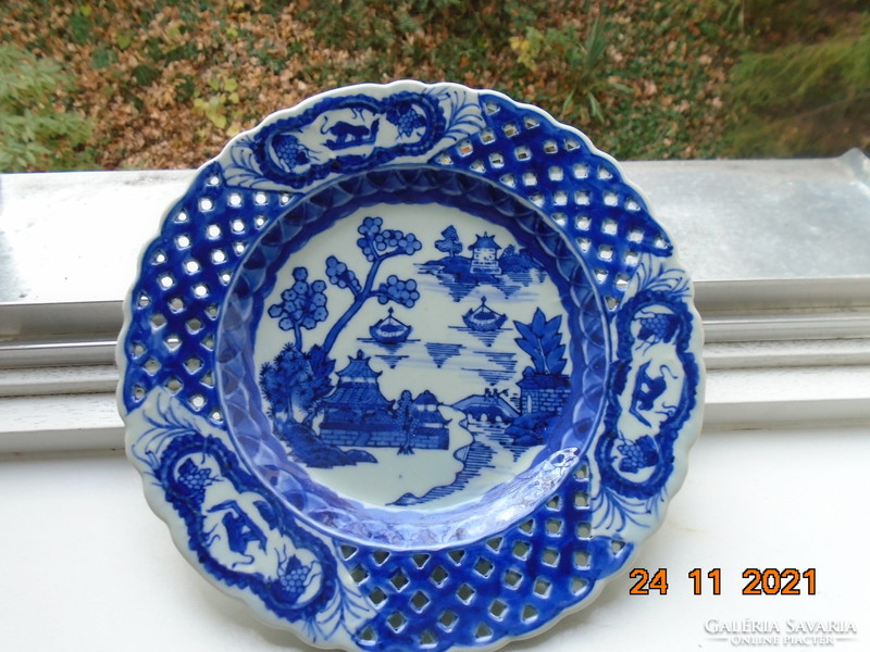 Chinese plate with hand-painted, hand-marked cobalt blue willow pattern, celadon glaze, pierced rim