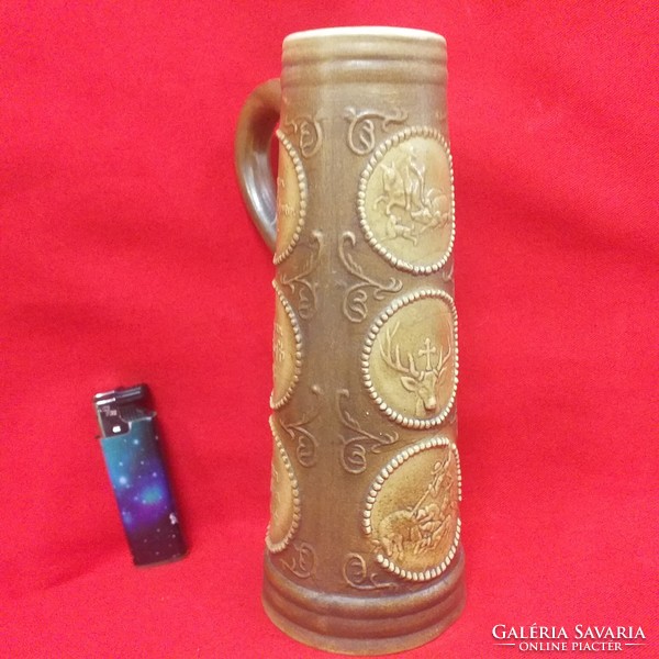 German hunter scene ceramic beer mug with drum pattern. 21 cm.