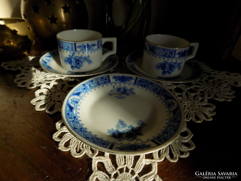 Two small cups with three plates