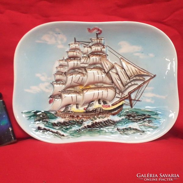 A sailing ship with a relief pattern on the sea, wall ceramics.