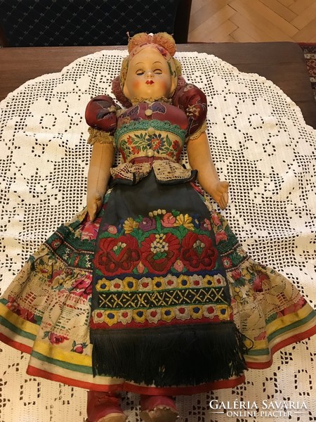 Baby in folk-matyo dress with painted porcelain head. Injury-free condition.