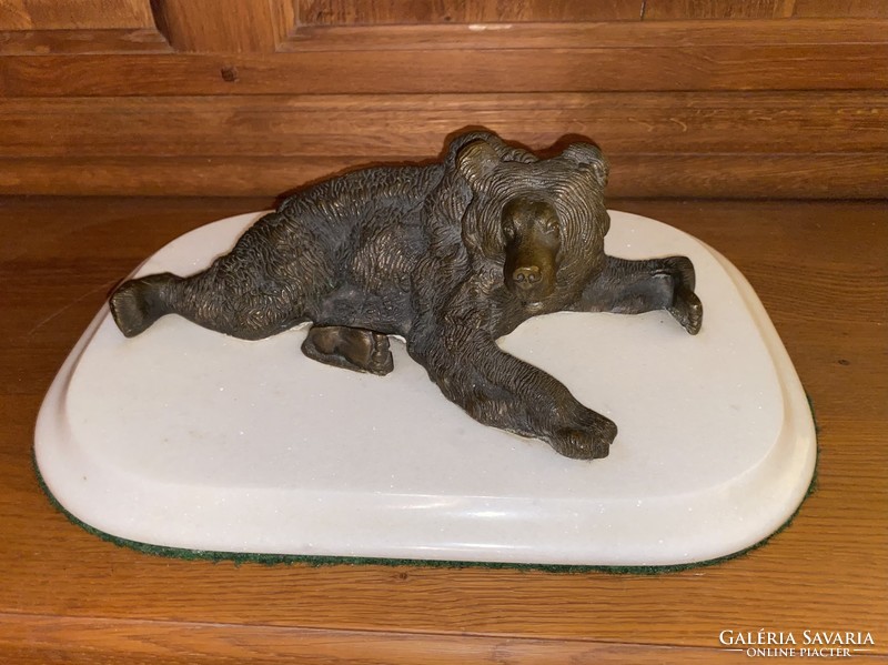 Bronze bear statue on a marble pedestal