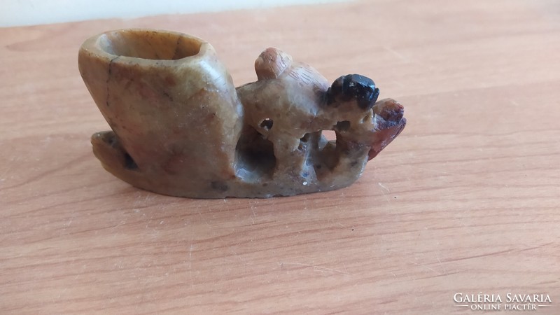 Small stone carving with a monkey figure