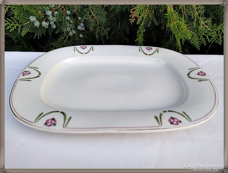 Large, antique, thick-walled porcelain bowl with a rosy garland pattern.