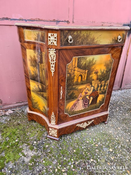 A drum chest painted with a gentleman's scene