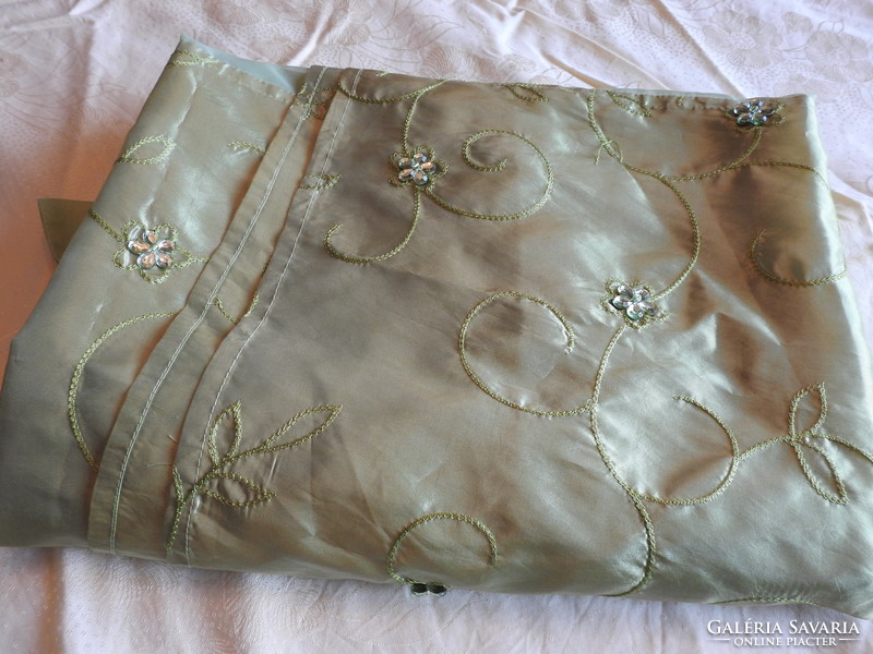 Translucent muslin curtain decorated with green beads