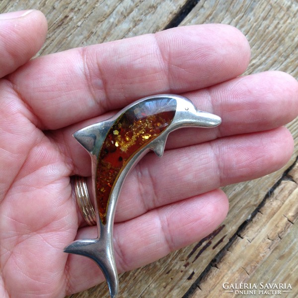 Silver dolphin brooch decorated with amber stone