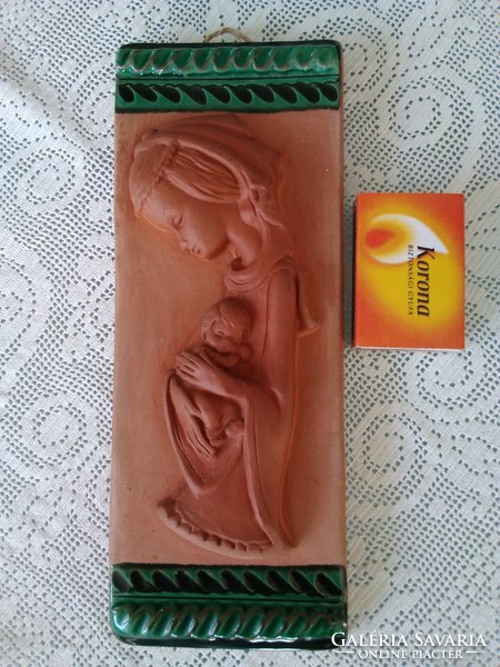 Mary is a terracotta wall picture with your little Jesus, with green ceramic glaze decoration on the top and bottom!
