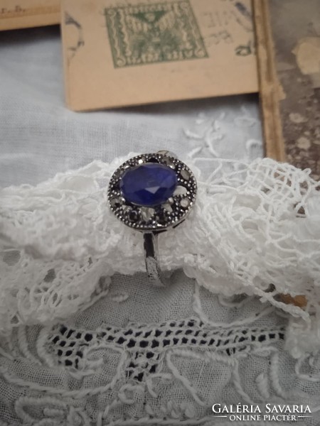 Old jewelry ring decorated with sapphire-like stone and marcasite.