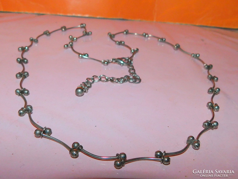 Stainless steel necklace with many spherical and curved shapes