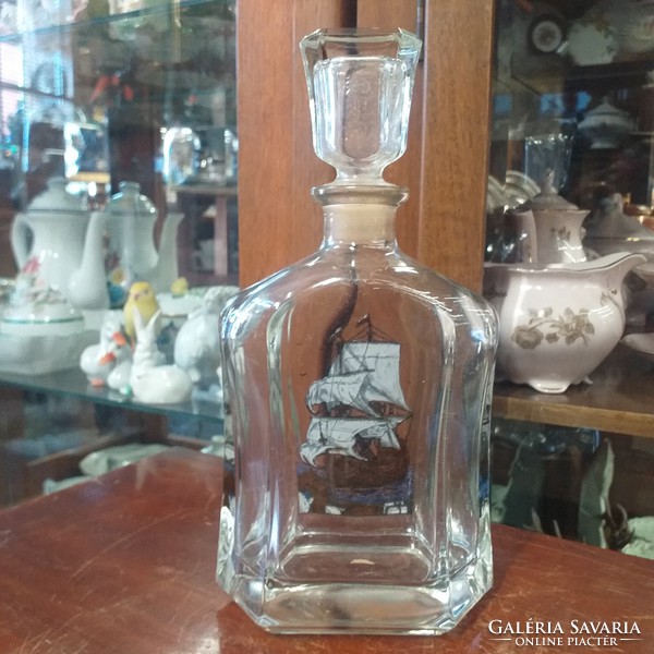 Liquor thick glass bottle with sailing decoration.