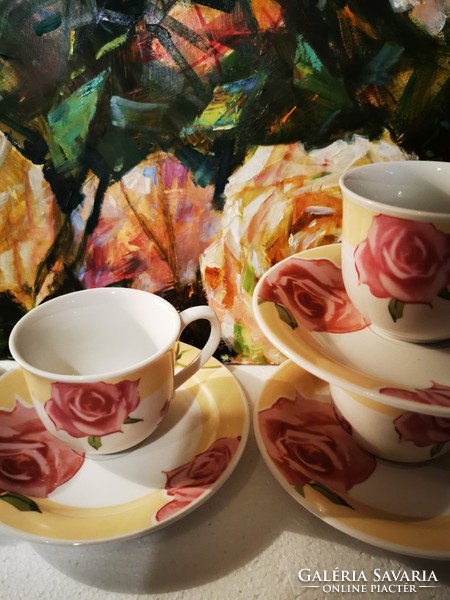 Four rosy porcelain teacups and placemats
