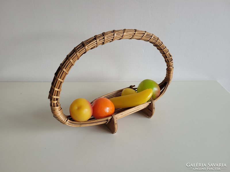 Old retro wicker basket on table offering fruit basket with plastic fruits