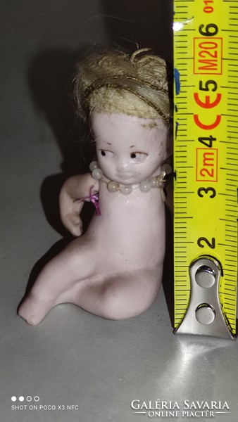 Antique porcelain is a very rare marked mini sitting doll
