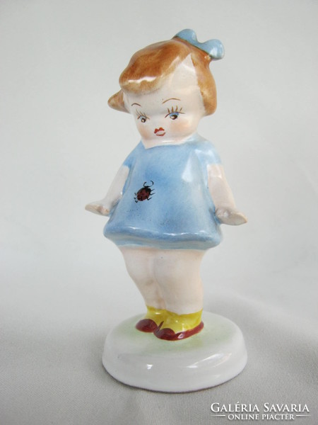 Little ladybug girl in ceramic blue dress in Bodrogkeresztúr
