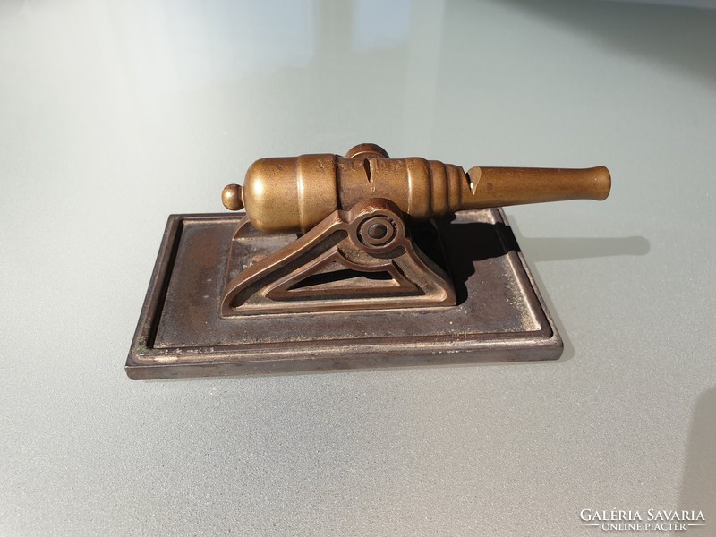 Old vintage table decoration with bronze cannon on copper table ornament