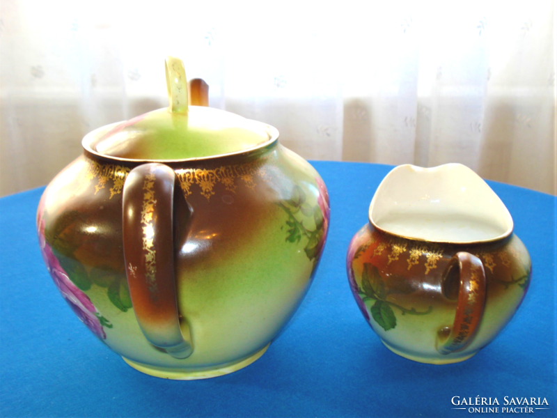 Antique rose patterned teapot, tea serving and milk, cream or lemon pouring jug