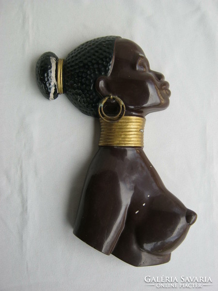 Nude african ebony nutmeg woman with metal retro wall ornament
