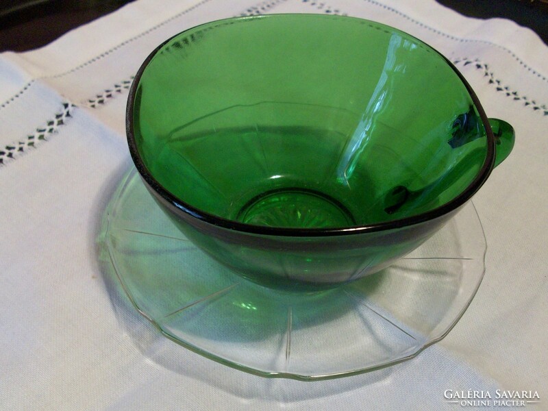 Old green color tea cup with placemat