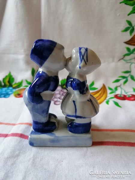 Kissing kids with tiny porcelain figurines