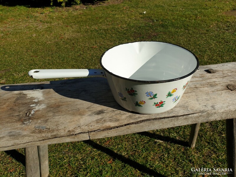 Old vintage enamel flower pattern in enameled large bowl with pouring milk