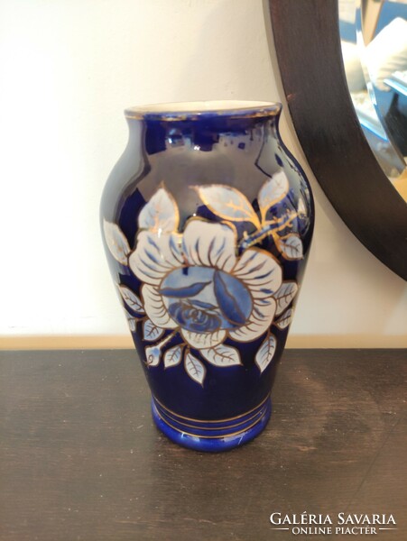 Beautiful antique raven rhyolite porcelain vase with lush floral motif in royal blue with white gold contour