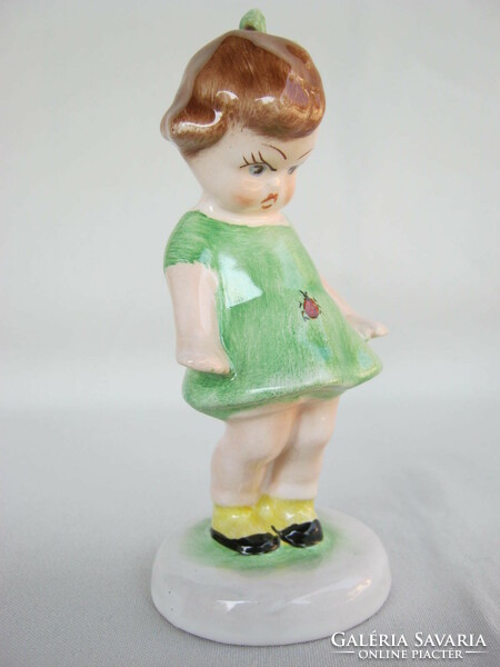 Bodrogkeresztúr ceramic little girl in a green dress with a ladybug