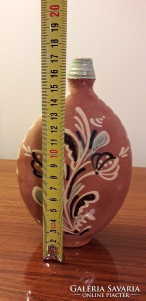Old ceramic water bottle with folk motif cognac boutique bottle