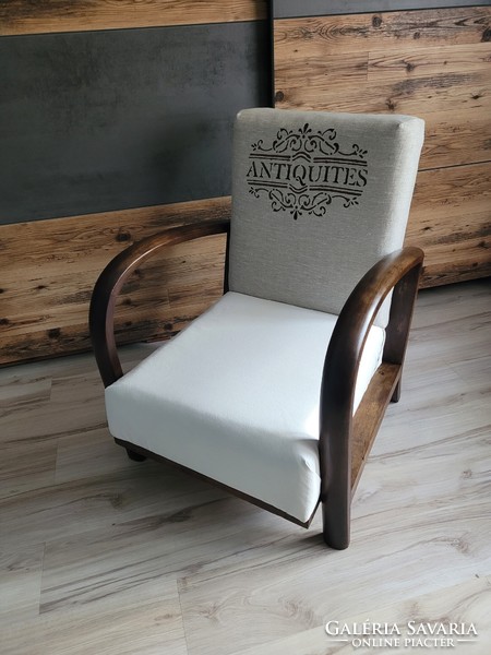 Vintage, slightly rustic armchair with huge wooden armrests