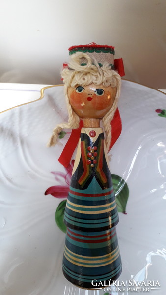 Old Russian wooden girl in traditional costume. Hand painted, wonderful