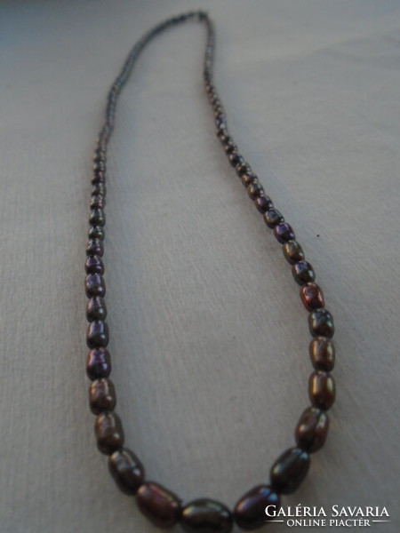 It's real. Extra fancy true pearl necklace with smaller rice grains multicolor