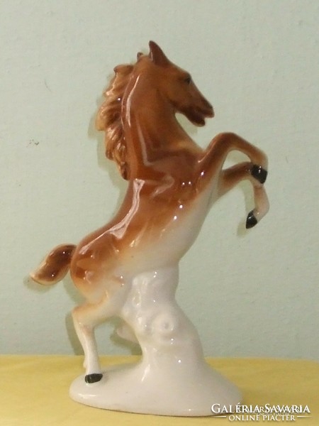 Brown perched porcelain horse.