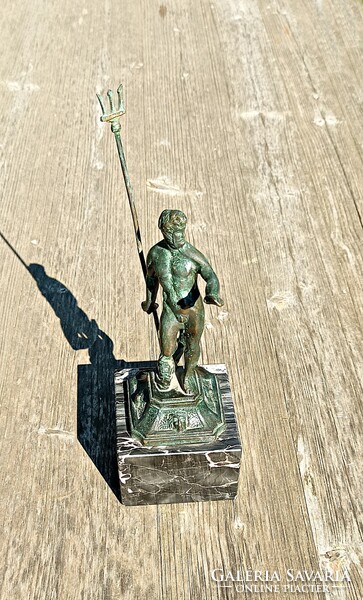 Antique bronze mercury statue on a marble pedestal