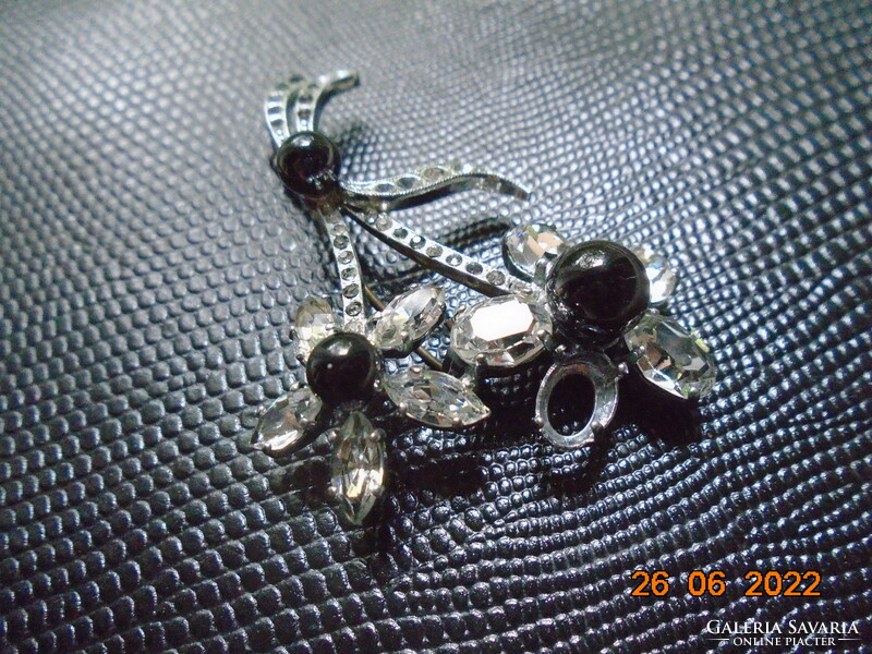 Silver-plated flower brooch with 3 black stones, polished, faceted rock crystal petals in a claw socket