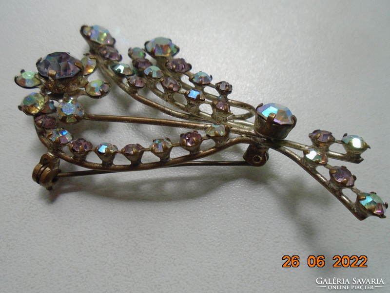 Antique brooch with iridescent polished stones in claw sockets