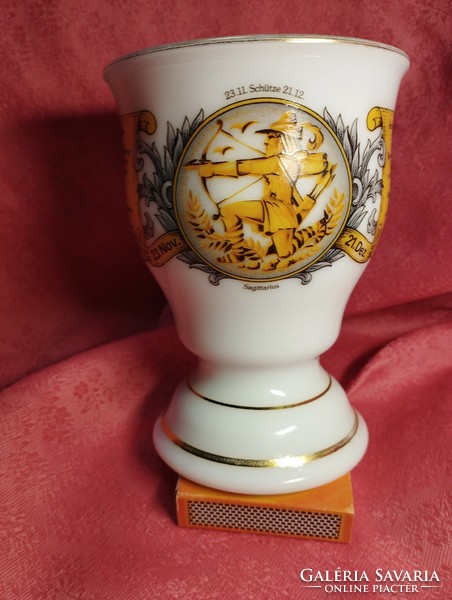Molded milk glass goblet, cup with arrow horoscope, gilded edges.