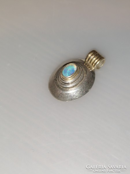 Silver-plated pendant decorated with an opal stone. Partially gilded.