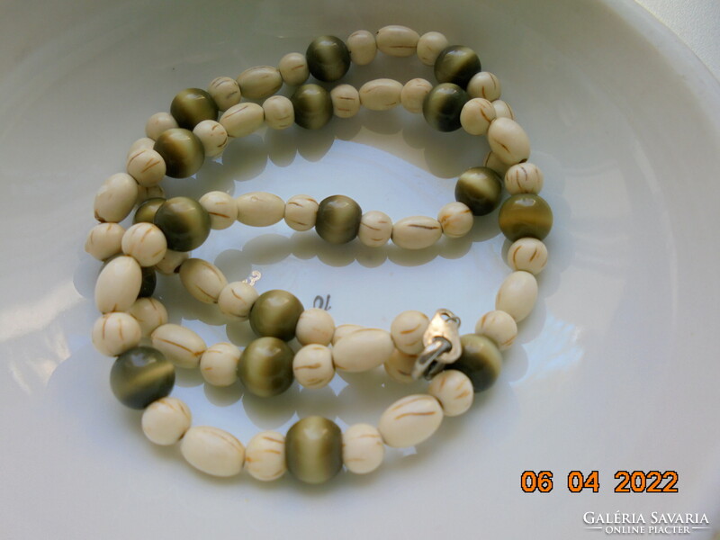 Necklaces made of carved bone and tiger eye beads