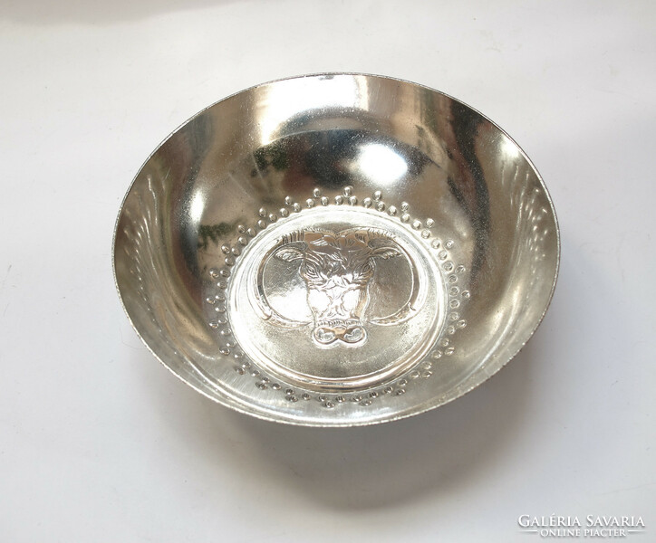 Silver bowl with bull's head decoration.