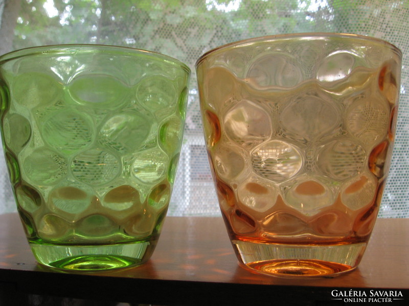 A pair of green and pink polka dot candle holders
