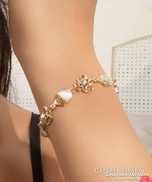 Gold-colored bracelet, cat's eye stone with acorn shapes and cut-out white crystals